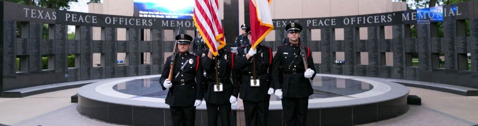 4 Officers in front of the Texas Peace Officer Memorial